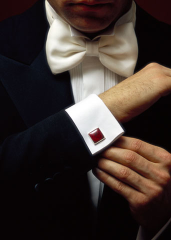 “A cufflink is a decorative fastener worn by men or women 